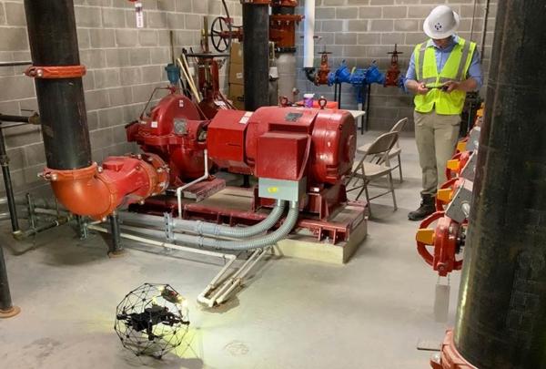 Person operating drone on construction site.